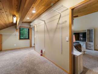 Discover ample storage in this spacious room featuring a large walk-in closet with extensive shelving and hanging space.
