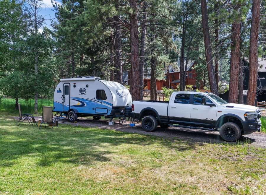 Experience the ultimate outdoor adventure with this fully equipped RV and truck combination, perfect for exploring scenic landscapes.