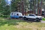 Experience the ultimate outdoor adventure with this fully equipped RV and truck combination, perfect for exploring scenic landscapes.