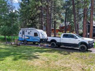 Experience the ultimate outdoor adventure with this fully equipped RV and truck combination, perfect for exploring scenic landscapes.