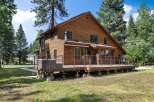 Experience rustic charm in this beautiful wooden home, featuring a spacious deck perfect for outdoor entertaining.