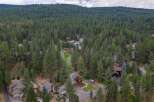 Nestled amidst a dense forest, this property offers a serene retreat with multiple homes scattered among towering pine trees.