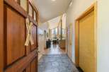 Step into this welcoming entryway featuring a rustic wooden door adorned with charming ski decor.