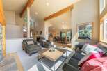 Experience the warmth of this inviting living space, featuring exposed wooden beams and a cozy stone fireplace.