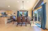 Experience comfortable dining in this spacious room featuring a large wooden table with plush leather chairs, perfect for family gatherings.