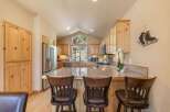This spacious kitchen boasts beautiful light wood cabinetry and granite countertops, perfect for meal preparation and entertaining.