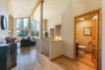 Experience breathtaking natural beauty from this stunning home, featuring expansive windows that frame panoramic views of lush evergreen trees.