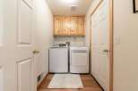 This laundry room features a stacked washer and dryer for efficient use of space.