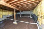 Explore the potential of this unfinished basement, featuring a robust subfloor drainage system and ample space for customization.