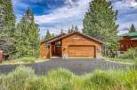 Nestled amidst tall pine trees, this charming wooden cabin offers a serene mountain retreat.