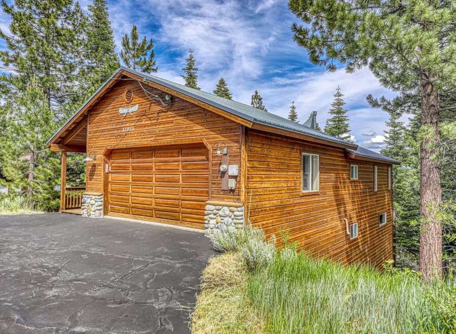 Discover this charming wooden cabin nestled amongst tall pine trees, offering a serene mountain retreat.