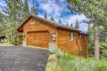 Discover this charming wooden cabin nestled amongst tall pine trees, offering a serene mountain retreat.