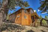 Nestled amongst tall pine trees, this stunning wooden home offers a rustic mountain retreat.