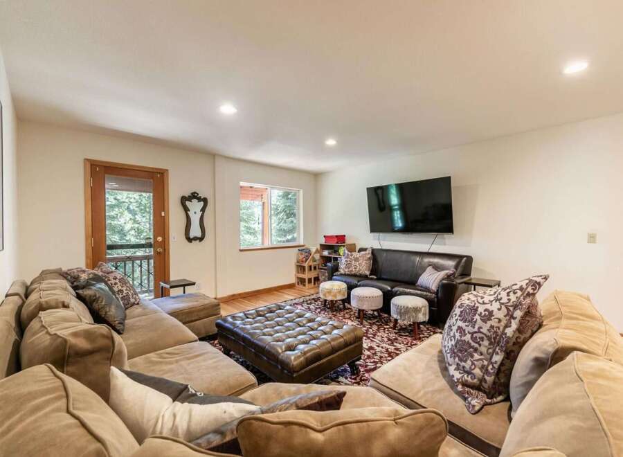 Experience ultimate relaxation in this spacious living room, featuring a large, plush sectional sofa perfect for gathering with loved ones.