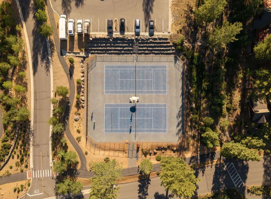Discover this stunning property featuring two pristine tennis courts, perfect for recreation and exercise.