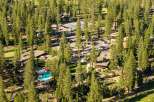 Experience luxury living surrounded by nature with this stunning property featuring a resort-style pool and a charming outdoor dining area.