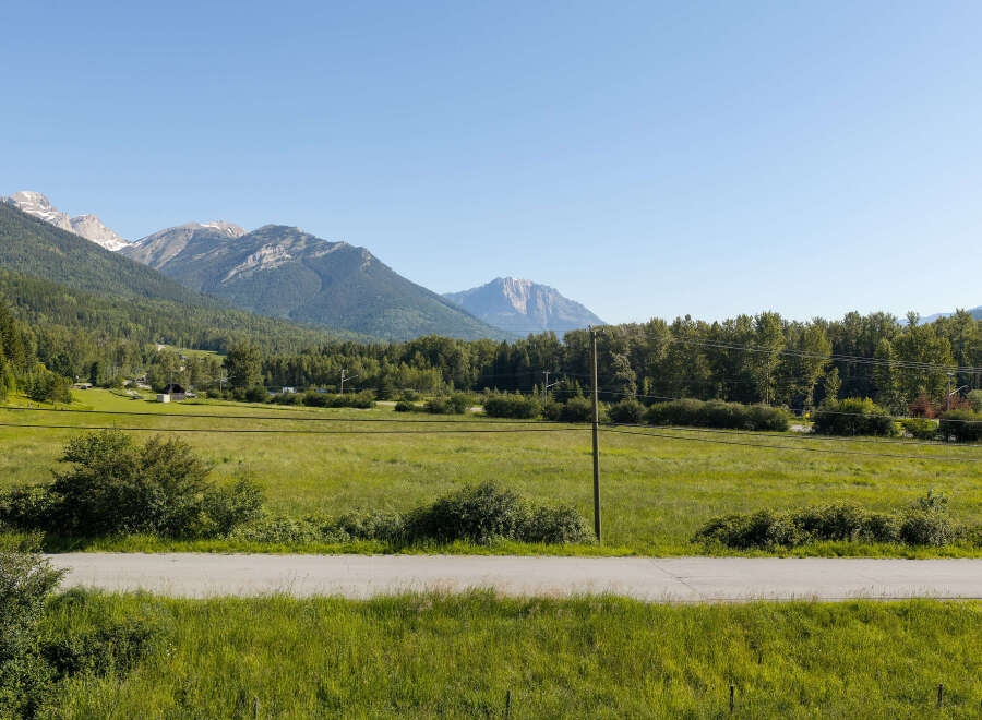 Experience the serene beauty of this property, nestled amidst rolling green fields and majestic mountains.