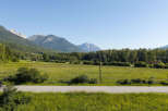 Experience the serene beauty of this property, nestled amidst rolling green fields and majestic mountains.