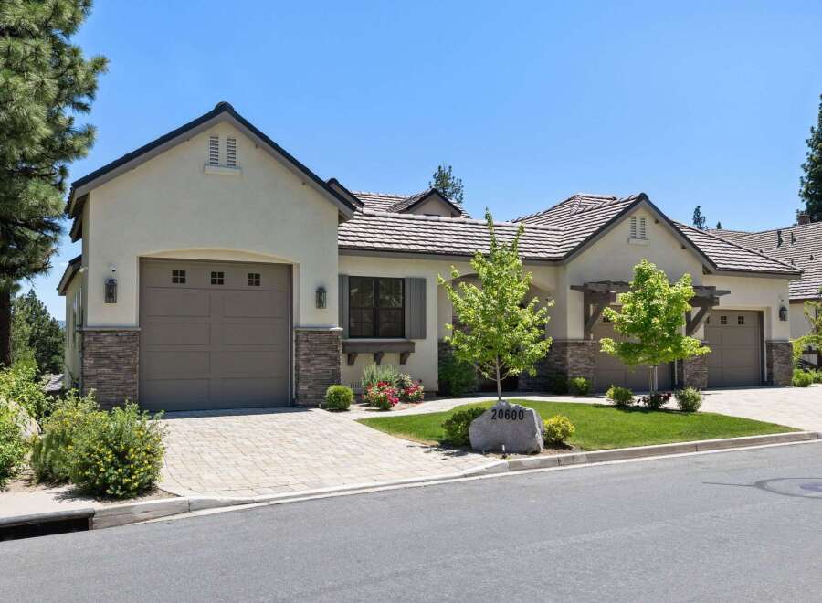 Discover this stunning home featuring a modern stucco exterior with stone accents and a durable tile roof.