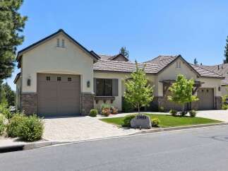 Discover this stunning home featuring a modern stucco exterior with stone accents and a durable tile roof.