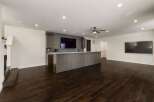 This modern basement features a sleek wet bar with a large island, perfect for entertaining guests.