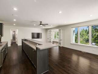 Experience modern living in this spacious home featuring a sleek wet bar perfect for entertaining.