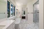 Experience luxury in this stunning bathroom featuring a freestanding soaking tub and a spacious marble shower.