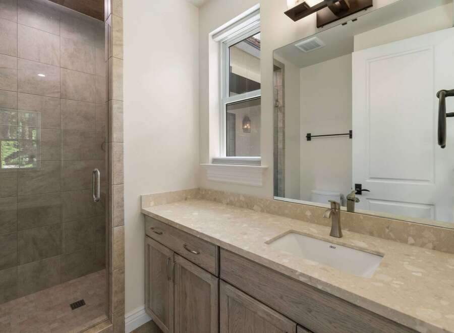 Experience modern luxury in this stunning bathroom, featuring a spacious walk-in shower with elegant tile work and a sleek glass enclosure.