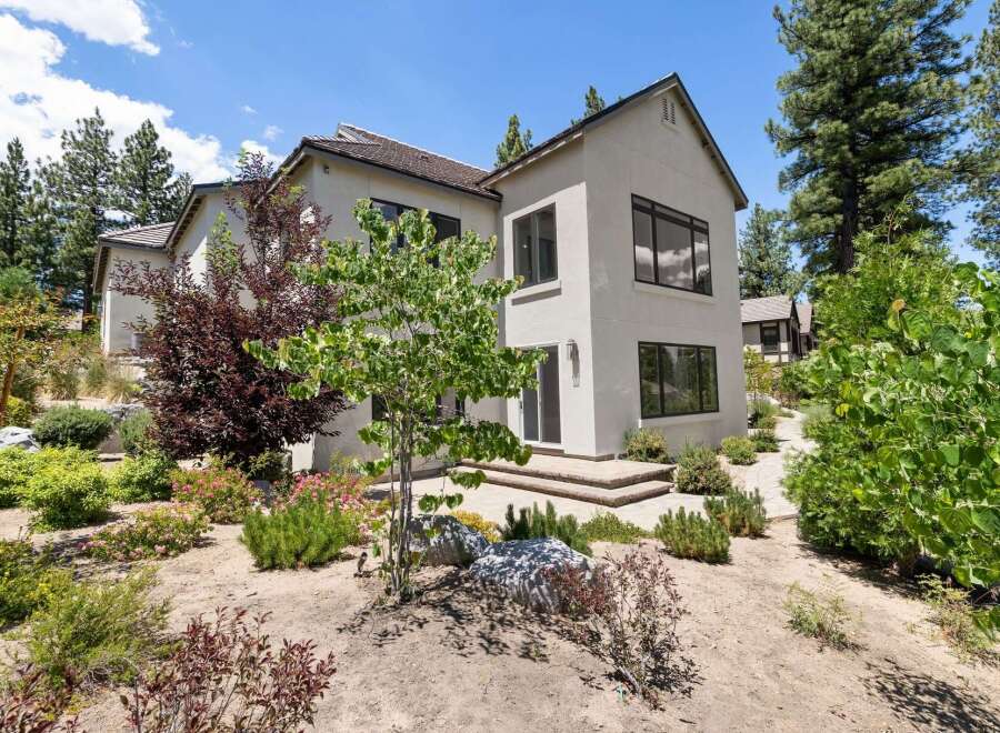 Discover modern living in this stunning home, featuring a sleek stucco exterior and expansive windows that invite natural light.