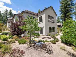 Discover modern living in this stunning home, featuring a sleek stucco exterior and expansive windows that invite natural light.