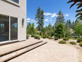 Step outside to a beautifully paved patio area, perfect for enjoying the serene surroundings.