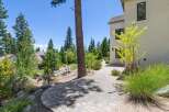 Discover this stunning property featuring a beautifully paved walkway leading through a lush, landscaped yard.