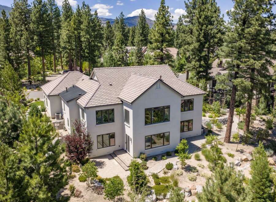 Experience luxury living in this stunning modern home nestled among mature pine trees.