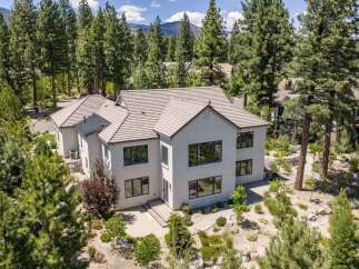 Experience luxury living in this stunning modern home nestled among mature pine trees.