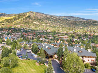 Experience luxury mountain living in this stunning property nestled amidst the scenic beauty of a ski resort town.