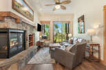 Cozy living room featuring a large stone fireplace with a roaring fire, perfect for chilly evenings.