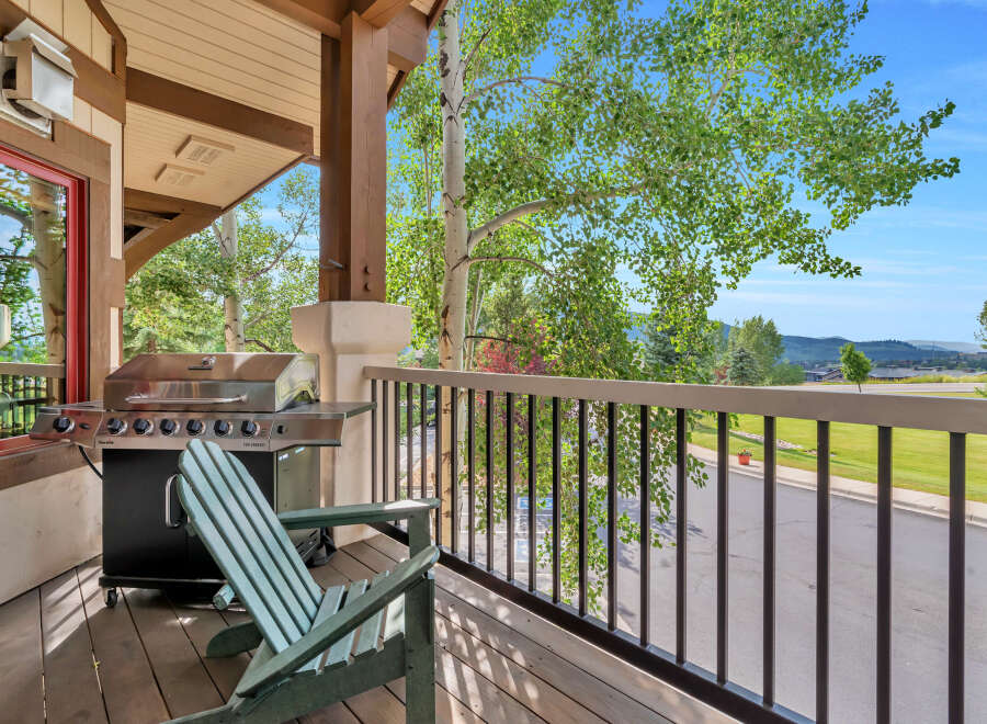 Enjoy outdoor living on this charming covered porch, complete with a stainless steel grill perfect for summer cookouts.