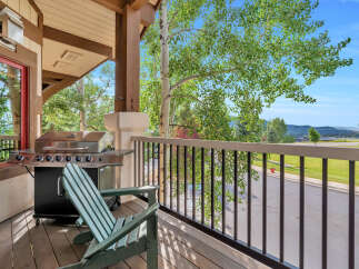 Enjoy outdoor living on this charming covered porch, complete with a stainless steel grill perfect for summer cookouts.