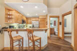 Experience the charm of this inviting kitchen, featuring warm wooden cabinetry and a convenient breakfast bar perfect for casual dining.