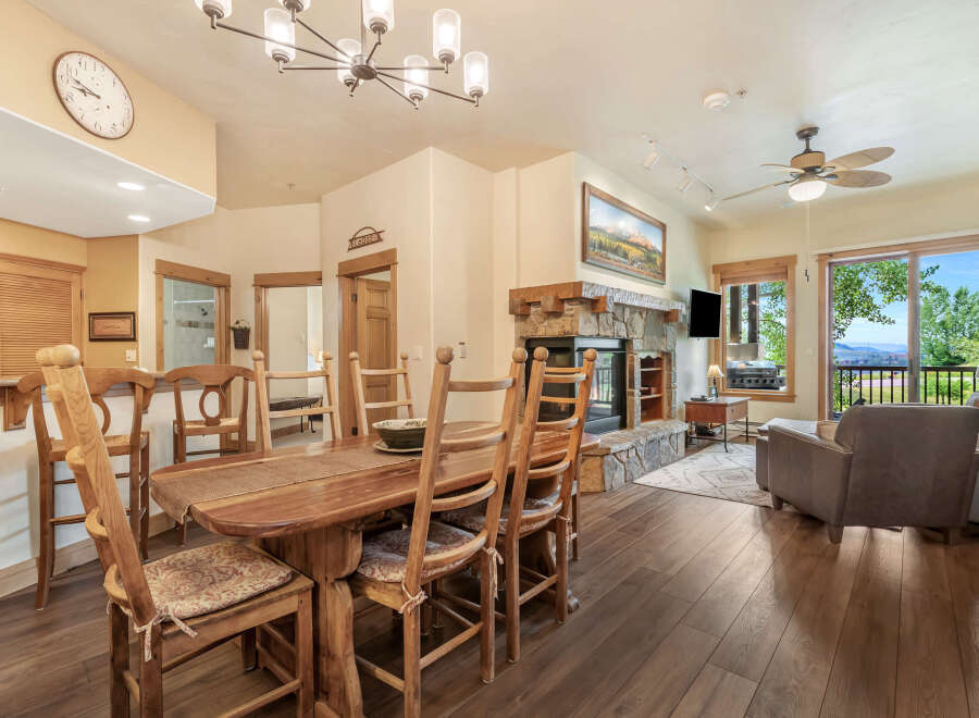 Experience comfortable living in this inviting dining area, featuring a rustic wooden table and chairs perfect for family meals.
