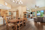 Experience comfortable living in this inviting dining area, featuring a rustic wooden table and chairs perfect for family meals.