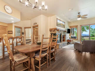 Experience comfortable living in this inviting dining area, featuring a rustic wooden table and chairs perfect for family meals.