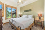 Experience comfort and style in this inviting bedroom, featuring a plush king-sized bed adorned with crisp white linens and a decorative accent pillow.