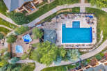 Experience luxury living with this stunning aerial view of a resort-style pool and spa area.