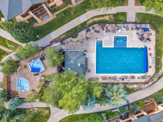 Experience luxury living with this stunning aerial view of a resort-style pool and spa area.