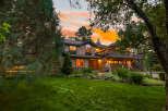 Experience the magic of twilight in this stunning home, nestled amidst lush greenery and mature trees.