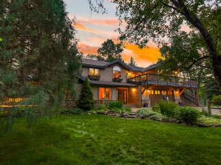 Experience the magic of twilight in this stunning home, nestled amidst lush greenery and mature trees.