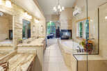 Indulge in luxury in this stunning master bathroom, featuring a spacious vanity with dual sinks and granite countertops.