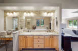 Experience luxury in this stunning master bathroom featuring a spacious double vanity with granite countertops and elegant stone tile backsplash.