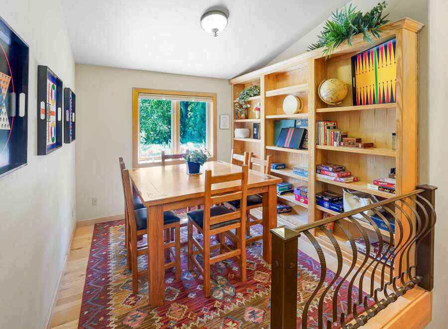 Gather around the charming wooden dining table, perfect for family game nights or intimate meals.